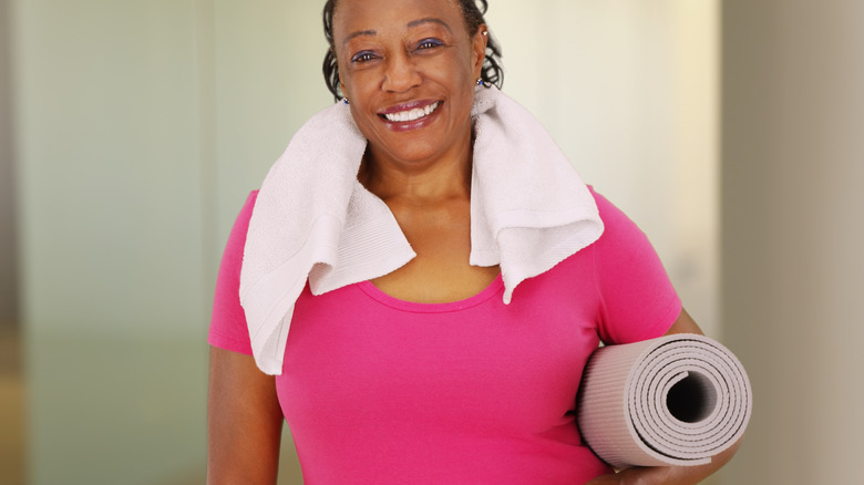 woman carrying yoga mat