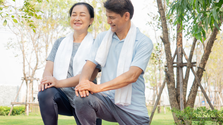 Asian man and woman stretching