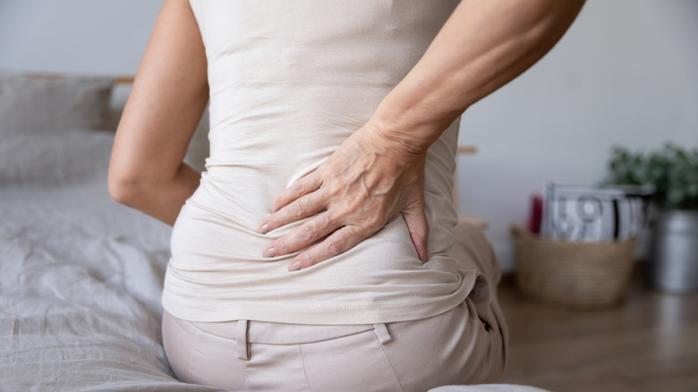 Woman holding back in pain