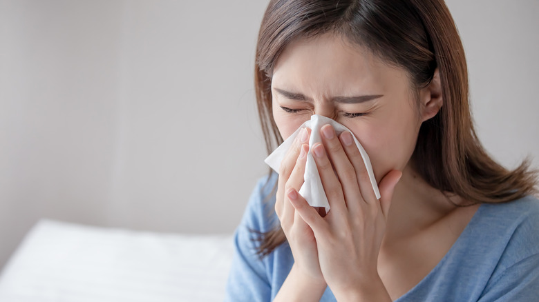 Woman sneezing