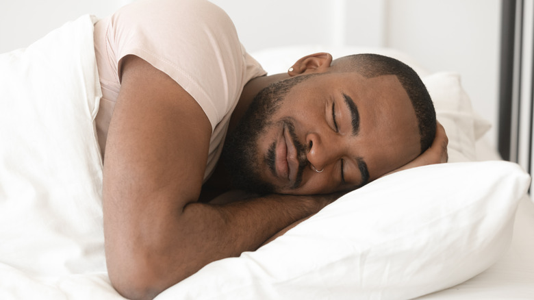 Man peacefully sleeping on orthopedic pillow
