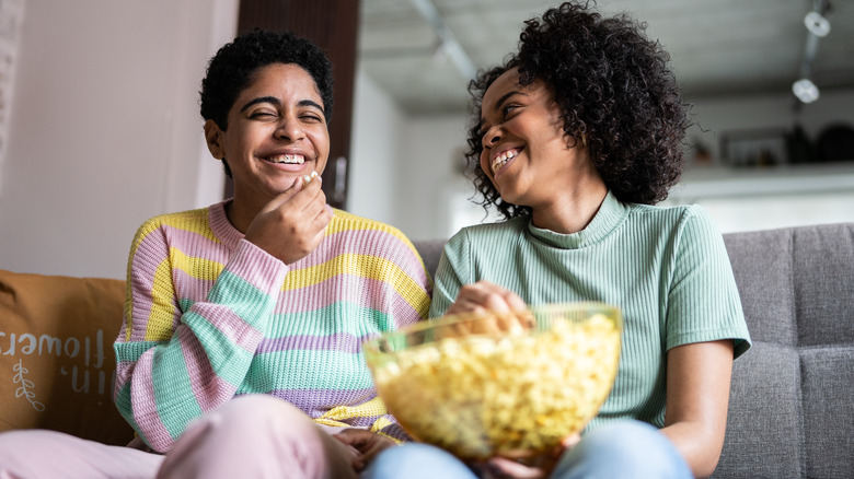 two women enjoying popcorn