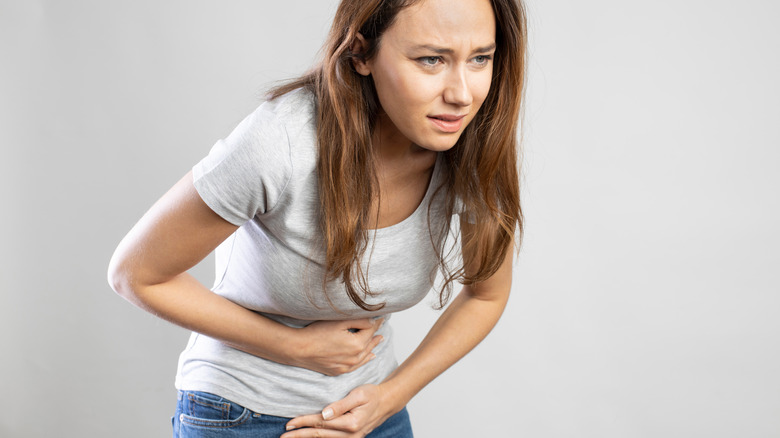 woman holding bloated stomach