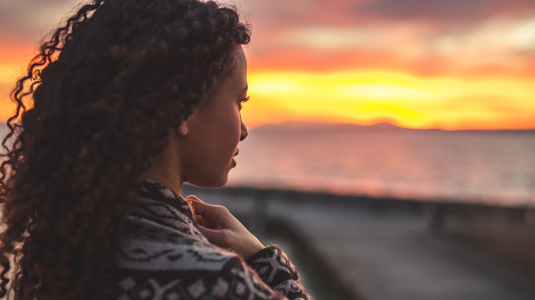 Woman staring at sunset