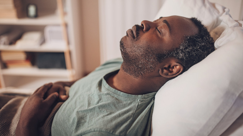 Sleeping man laying in bed