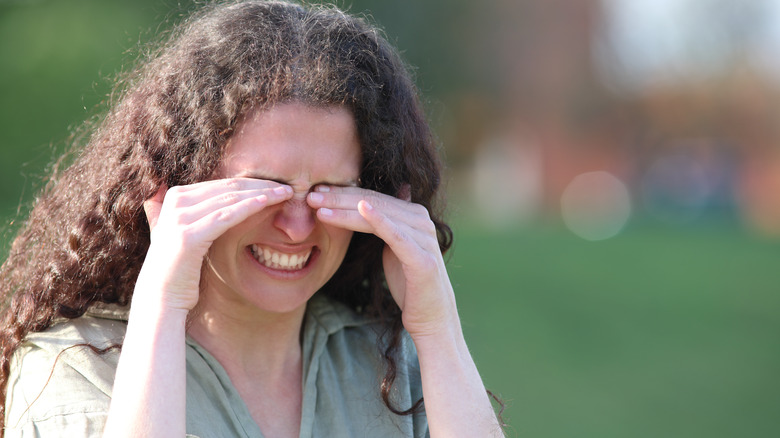 Woman rubbing eyes