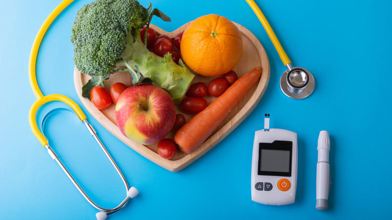 blood glucose monitor, stethoscope, and healthy foods