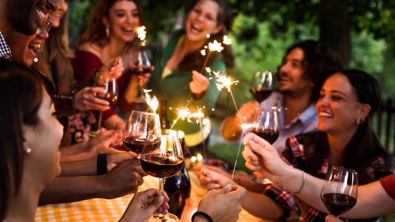 People celebrating with sparklers and food