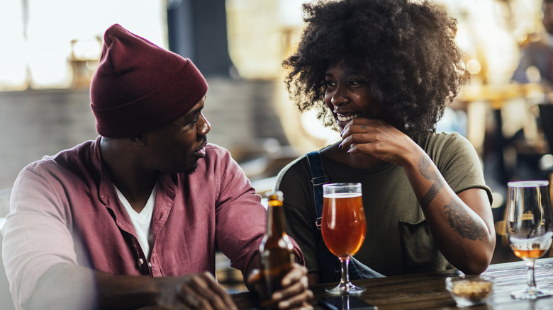 Couple flirting at bar