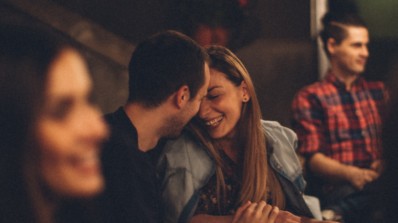 Couple laughing in group setting