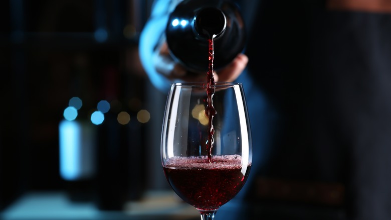 Hand pouring wine into glass