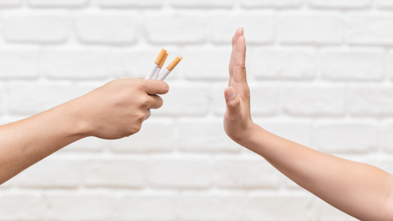 hand refusing cigarettes