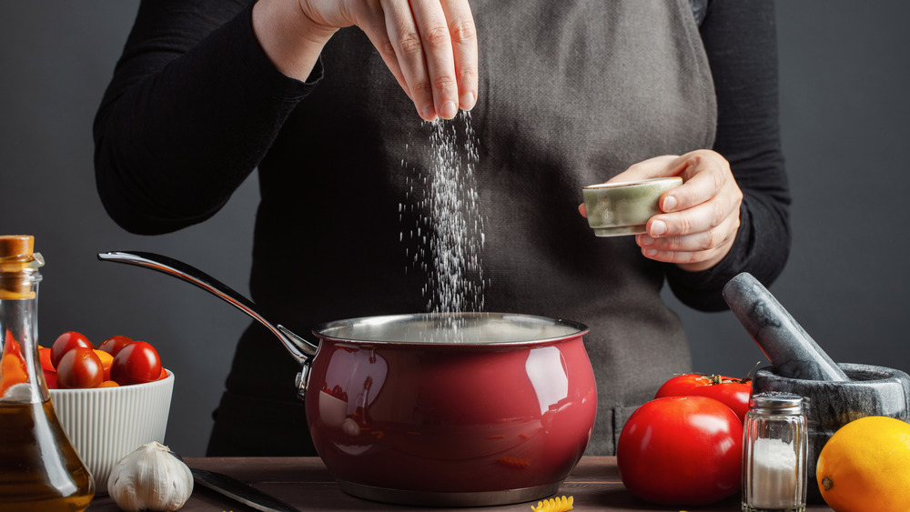 salting food in a pot