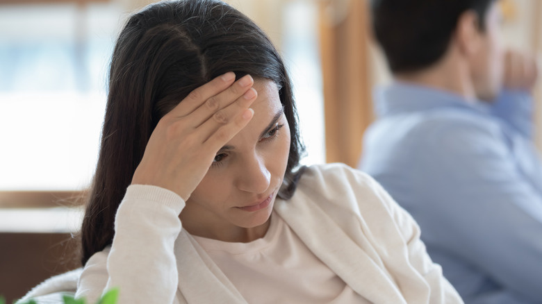 woman sitting on couch in depression