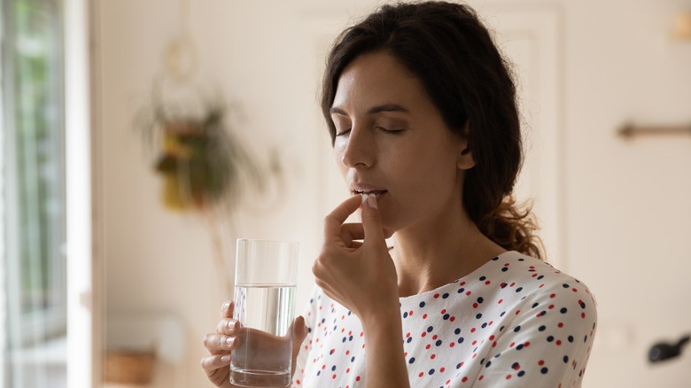 woman taking medications