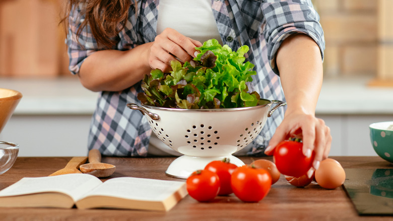 woman preparing a fresh salad with vegetables