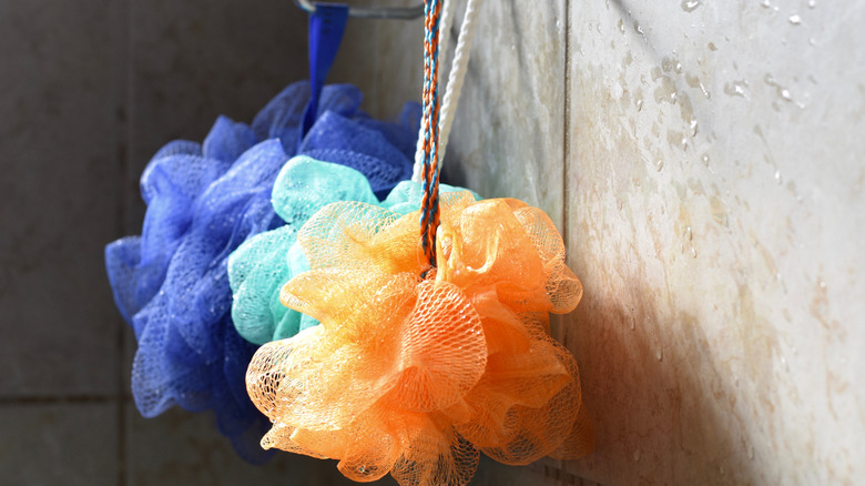 Colorful loofahs hanging from a rack