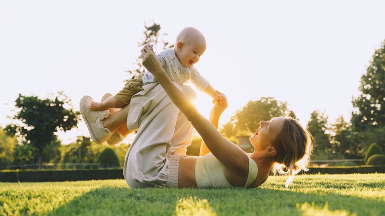 mother playing with child outside