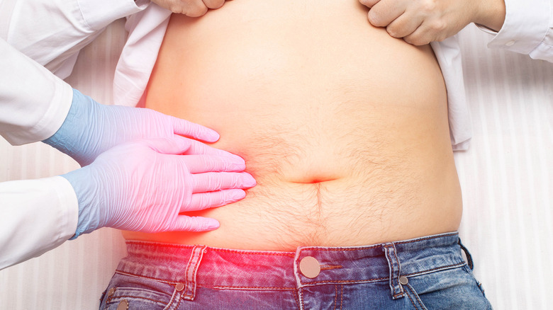 doctor touching patient's liver area