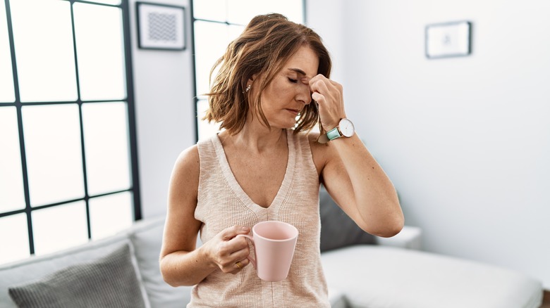 woman with headache and coffee