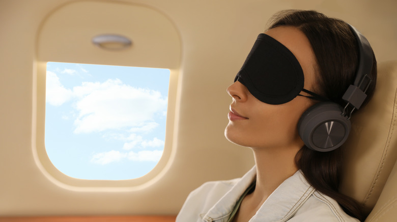 woman wearing sleep mask on plane