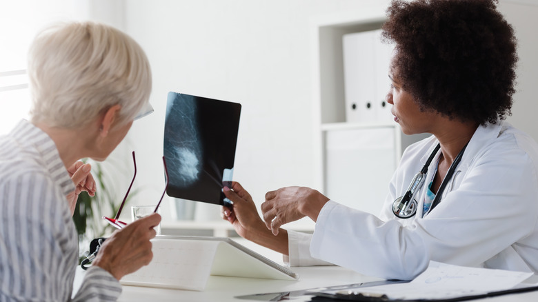 A doctor explains the results of a mammogram to her patient