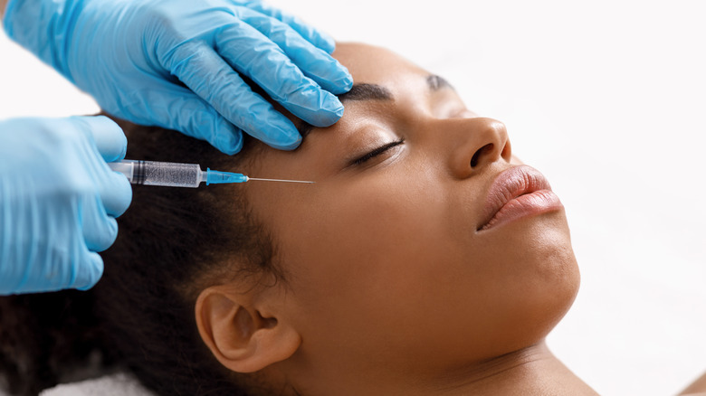 Black woman receiving eye injections
