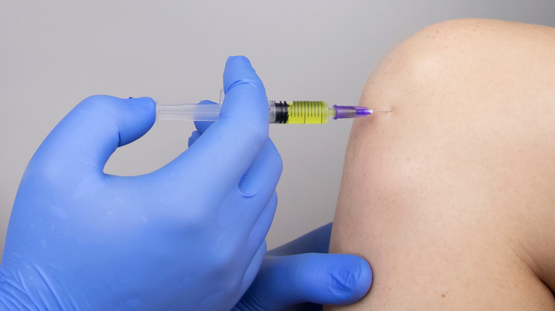 doctor giving steroid injection into knee