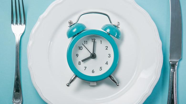 white dinner plate with blue alarm clock 