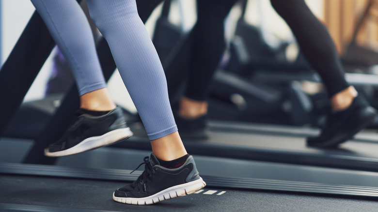 female legs in leggings on treadmills