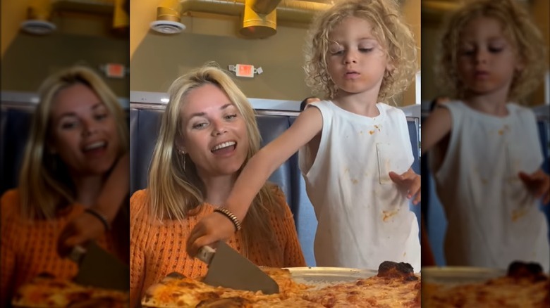 Kelly Hughes and her son eating pizza