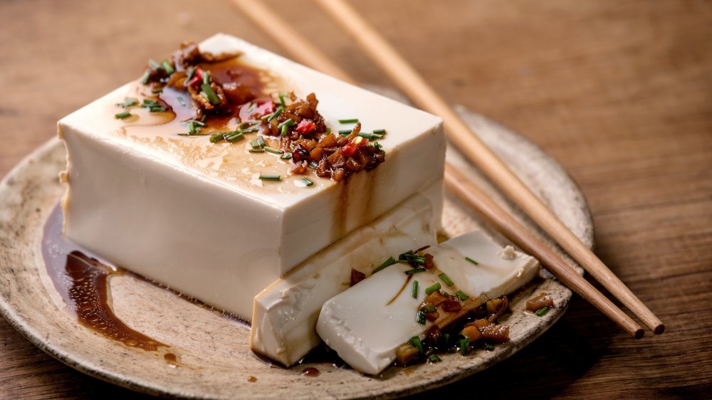 Japanese tofu with sauce on beige background.