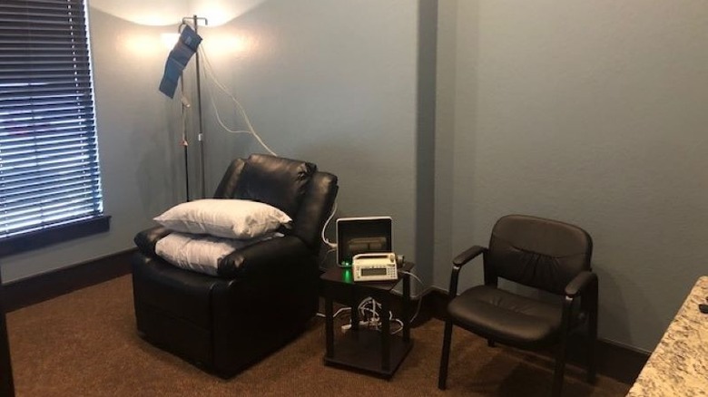 A room with a recliner, armchair, and IV stand where ketamine infusions are performed