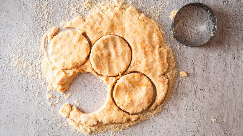 cutting biscuits out of dough