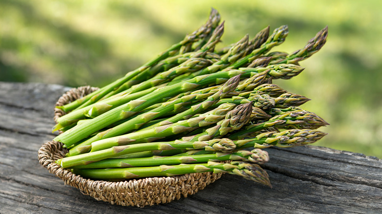 bunches of green asparagus in a basket