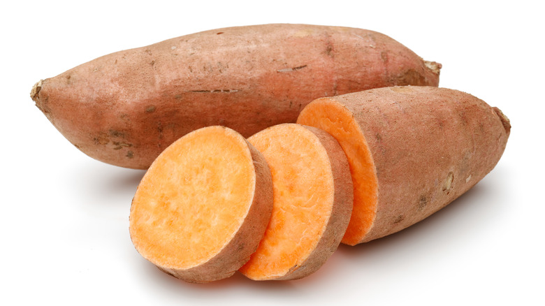 sweet potato with slices isolated on white background