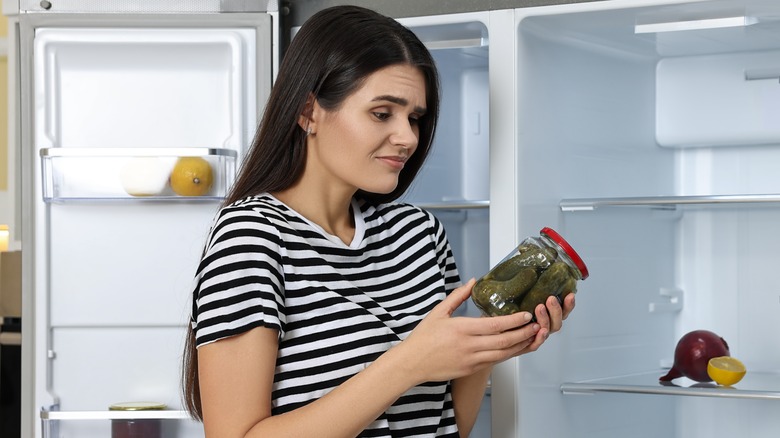 Woman staring at pickle jar