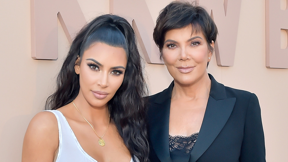 Kim Kardashian posing on the red carpet with her mom Kris Jenner