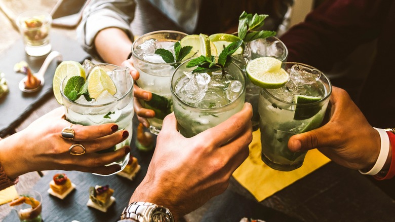 group cheersing with mojitos