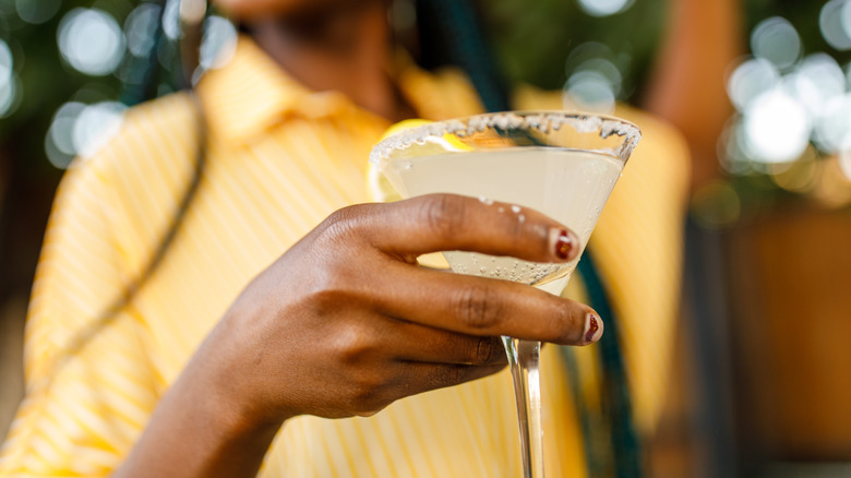 woman holding a martini glass with margarita