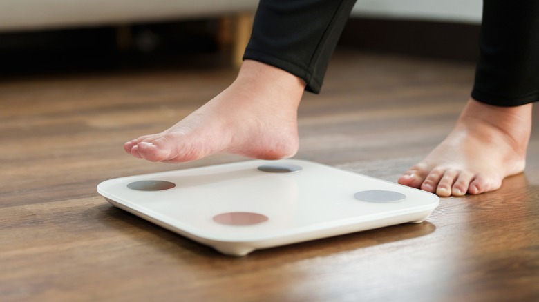Person stepping on a weighing scale