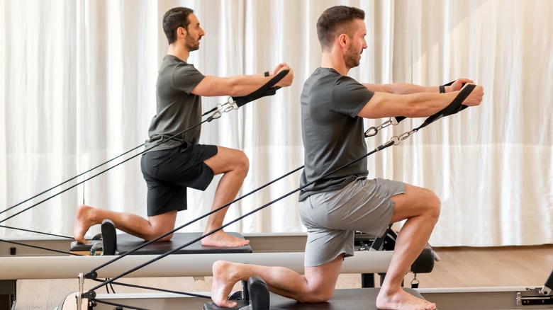 Men exercising on a reformer