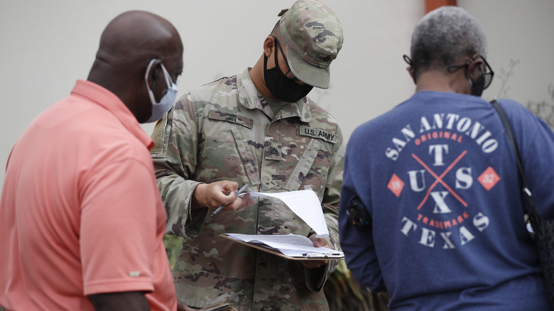 Man with mask looking at soldier with mask on