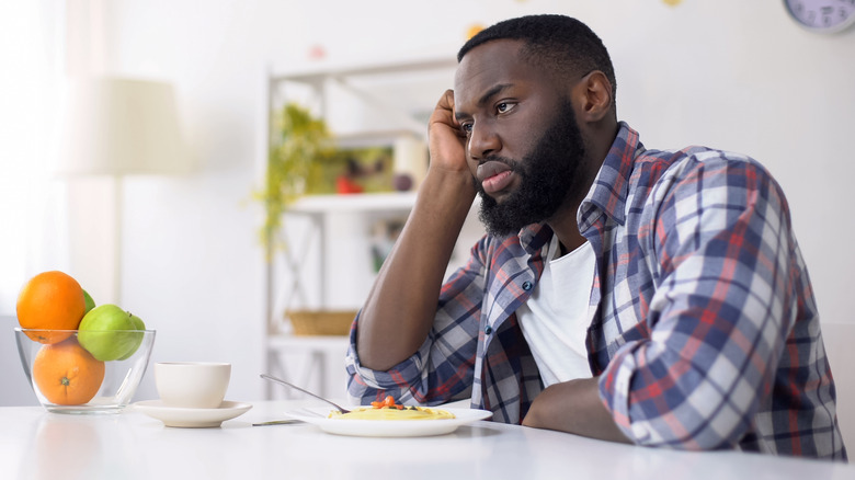 Man thinking and not eating