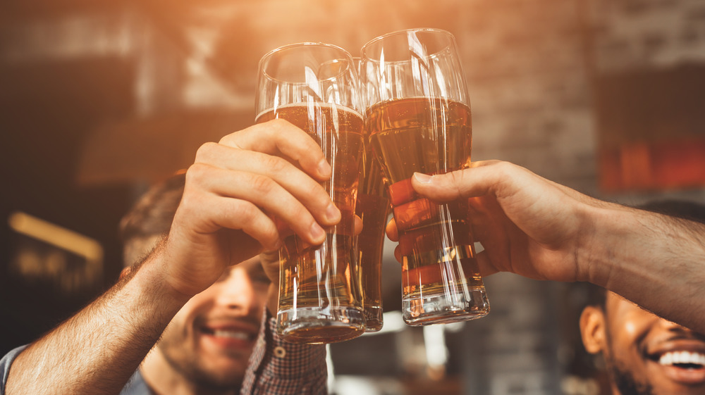 people holding beer glasses