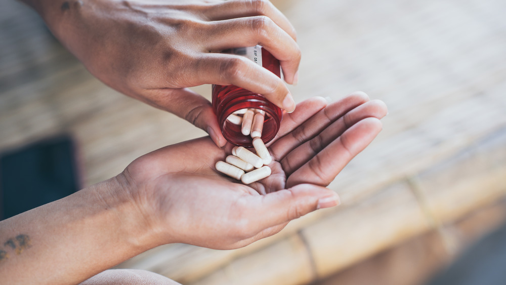 pills going into hands