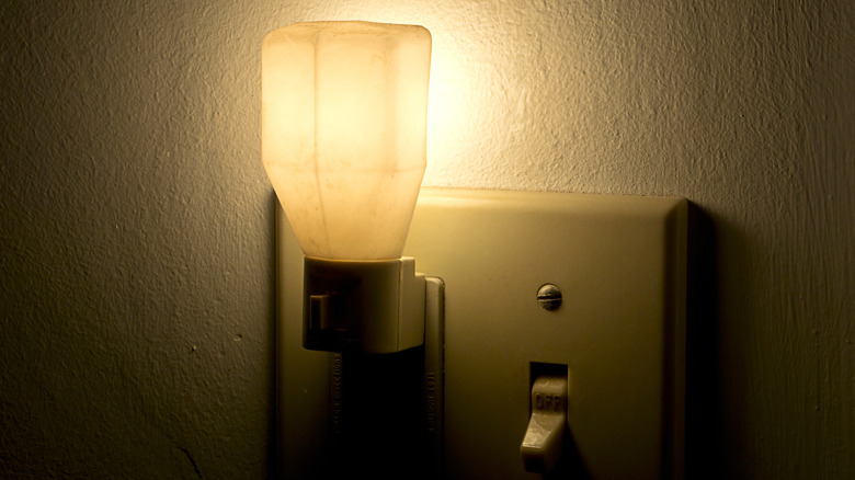 Night light plugged into wall next to light switch