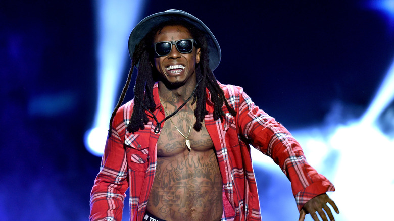 Open-shirted Lil Wayne performing