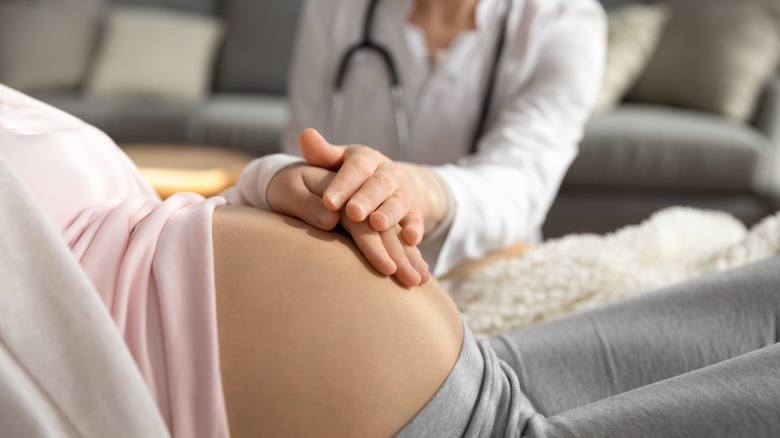 Doctor examining pregnant woman