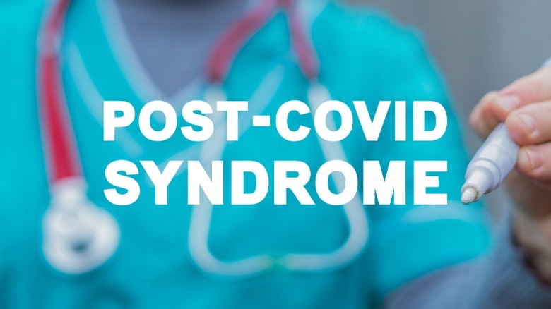 doctor writing words post-covid syndrome